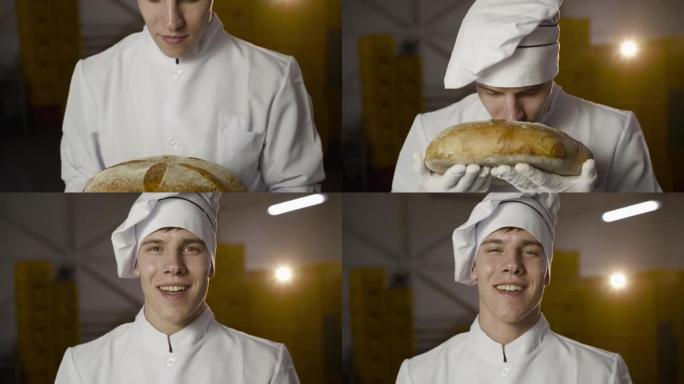 穿着制服的面包师嗅着一条面包，对相机感到愉悦和微笑