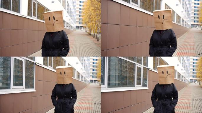 悲伤的纸袋脸带着面无表情的情绪走在街上。