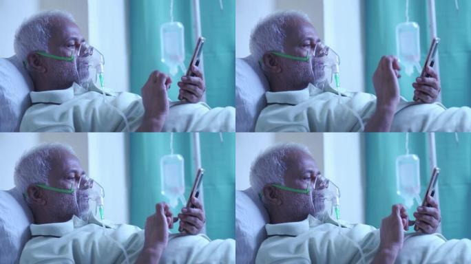 带呼吸机氧气面罩的患病老人手机健康状况报告-呼吸急促或肺部感染的概念新型冠状病毒肺炎冠状病毒感染的治