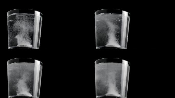 阿司匹林片剂落入装满水的玻璃烧杯中，开始嘶嘶并释放气泡。