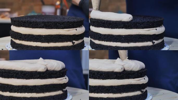 糕点厨师将一层厚厚的奶油挤在多层海绵蛋糕上