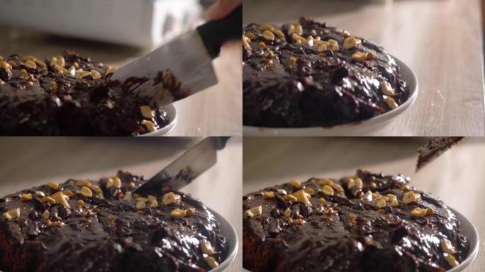 用桌上的腰果切成自制的巧克力甘纳许蛋糕馅料，慢动作。