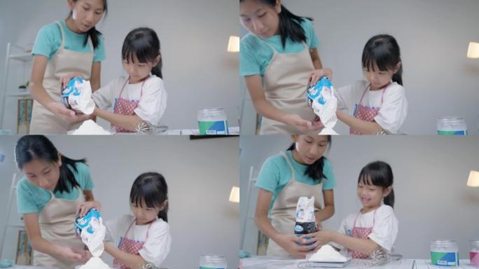 亚洲儿童在家里一起烤饼干前测量面粉准备，生活方式概念。