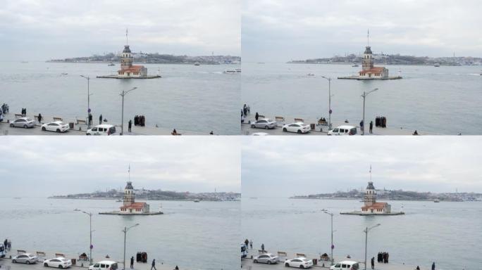 土耳其伊斯坦布尔现代城市博斯普鲁斯的少女塔。游客步行和拍摄从城市堤岸到Kiz Kulesi塔的风景。