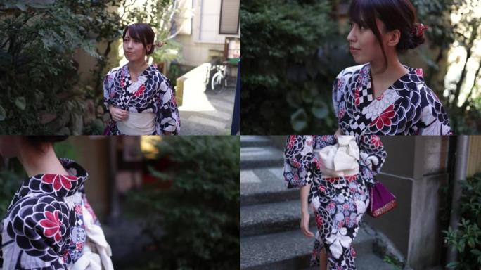日式浴衣的日本妇女在狭窄的道路上走上台阶