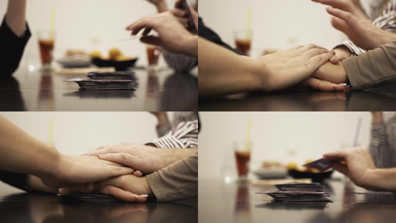 人们在玩纸牌游戏时叠手。特写。慢速mo