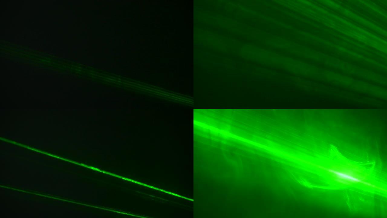 明亮的绿色霓虹灯激光光束在烟熏的黑暗工作室中闪烁并发出光。舞台灯。舞台上的灯光、照明、戏剧烟雾。假日