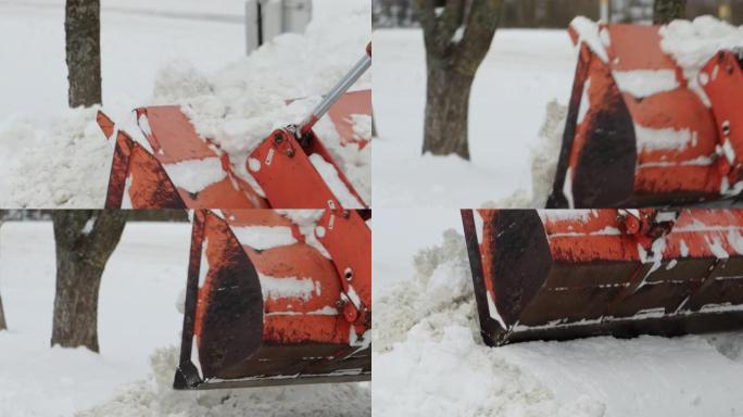 带有黄色桶的拖拉机在冬天从街上除雪。工业道路清洁援助