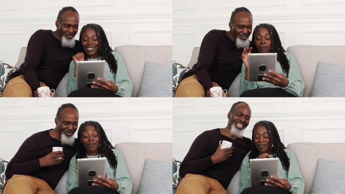 老年黑人夫妇使用平板电脑视频通话家人和朋友
