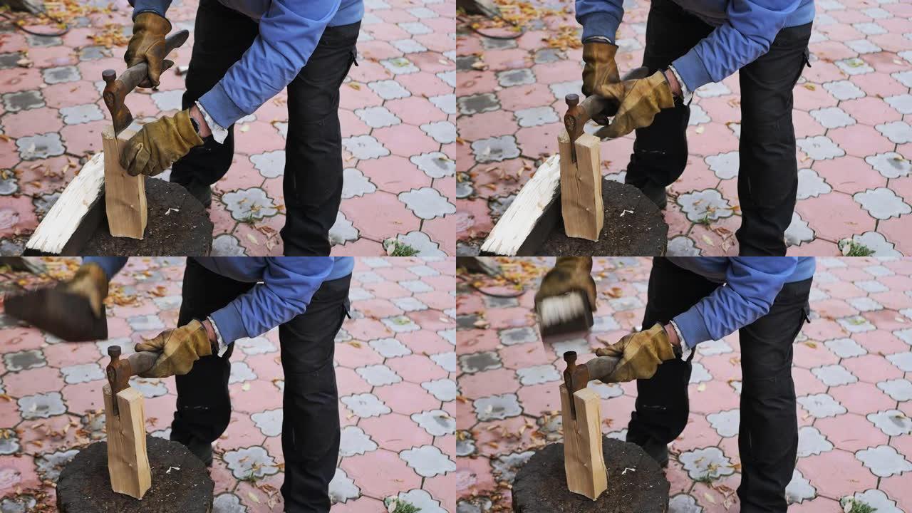 一个欧洲农民的手正在用铁斧砍柴。慢动作
