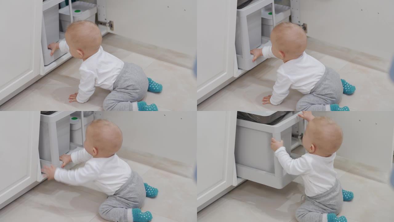 家庭对孩子有许多潜在的危险，婴儿打开柜子在厨房柜台下抓取和玩耍拉出垃圾桶，儿童在家中安全。