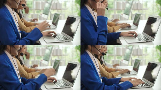 呼叫中心妇女在其工作站上支持并在键盘上打字