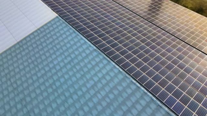 建筑屋顶上的蓝色光伏太阳能板表面鸟瞰图，用于生产清洁的生态电力。生产可再生能源的理念。