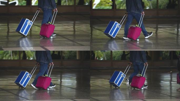 步行游客携带蓝色装甲防护钢手提箱，带粉色包。