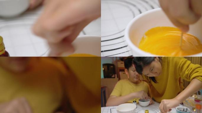 亚洲儿童在晚上在家中将糖中的颜色混合在一起装饰万圣节饼干。