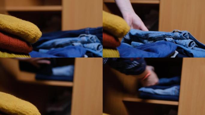 女人的手正在整理家用衣柜里的衣服
