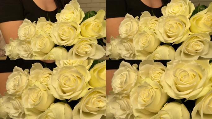 拿着大束玫瑰的女孩。摄像机的运动。