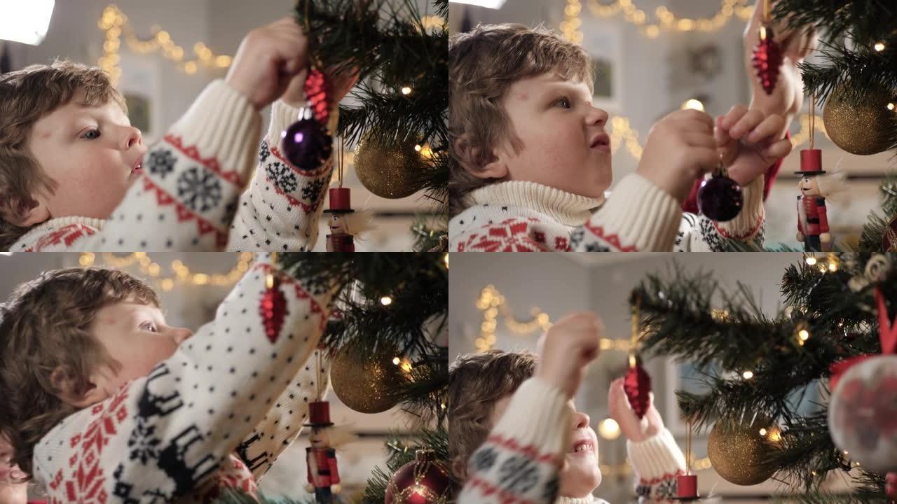Kod正在装饰圣诞树。把玩具放在圣诞树上的快乐孩子的脸。特写和慢动作