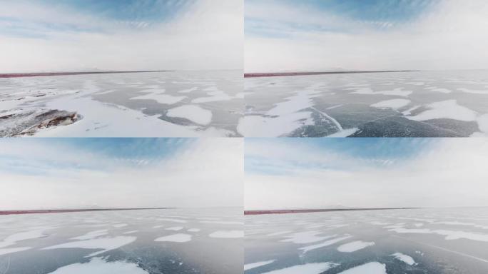 鸟瞰冰丘和冰冻湖的裂缝