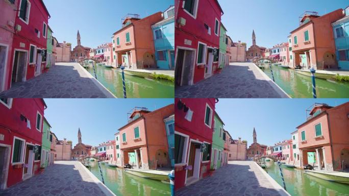 五颜六色的房屋矗立在布拉诺水渠的鹅卵石路上