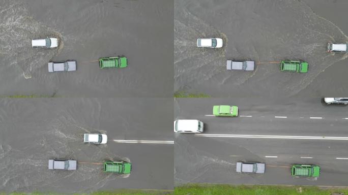 大雨过后，汽车在洪水泛滥的街道上行驶的城市交通鸟瞰图。道路排水系统存在问题。