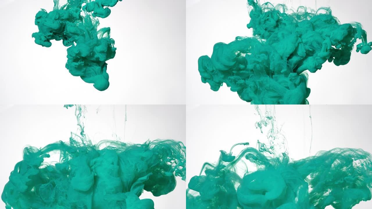 在白色背景上的水中薄荷绿色水彩墨水。彩色丙烯酸涂料在水中的慢动作。