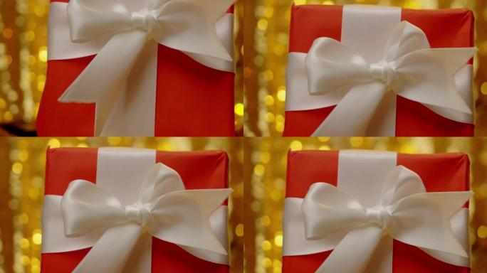 黄色bokeh背景的红色礼品盒，圣诞节和假期概念。