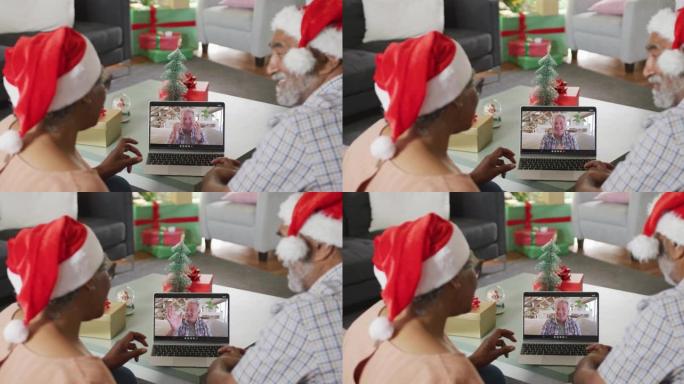 圣诞节期间，与资深男性朋友在笔记本电脑上视频通话时快乐的资深非洲裔美国夫妇