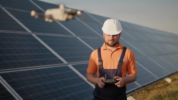 光伏太阳能发电厂戴着头盔和控制无人机的工业专家。太阳能电池板阵列安装。技术和生态。新技术