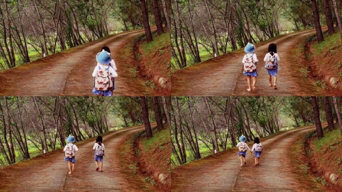 两个小姐妹互相牵着手，在晴天沿着松林路往前跑。