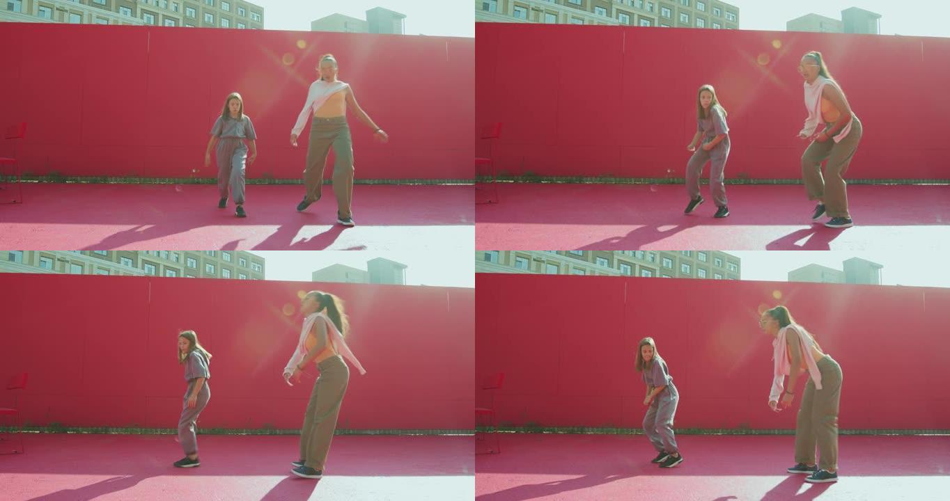 女舞者教练教青少年女童在阳光下跳舞。当代舞蹈学校广告