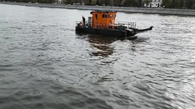 03.10.2020莫斯科俄罗斯一艘橙色驳船在城市范围内的傍晚沿着莫斯科河航行