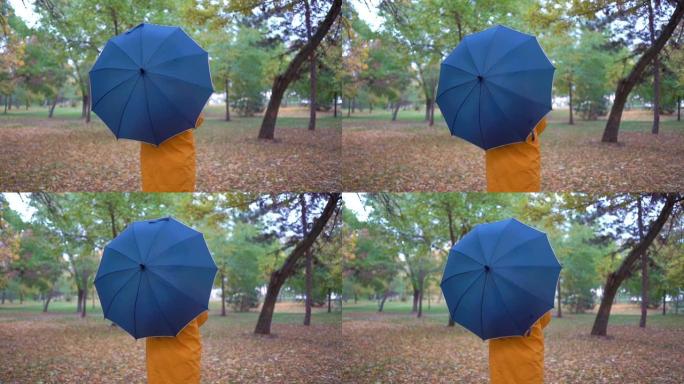秋季公园旋转雨伞背后的人