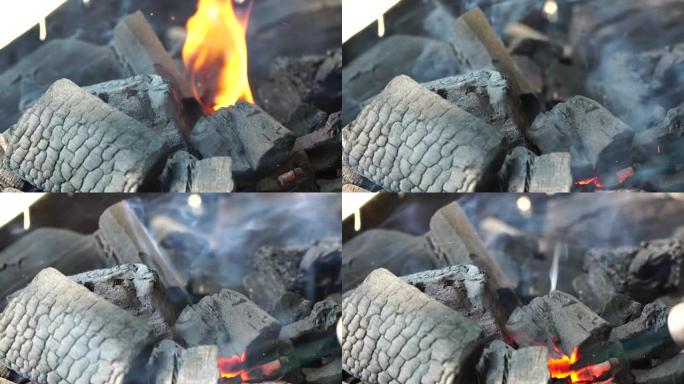 煤火和自然野餐背景上的火。烧掉篝火作为食物。闷烧的煤。烧烤中的灰烬。选择性聚焦。慢动作
