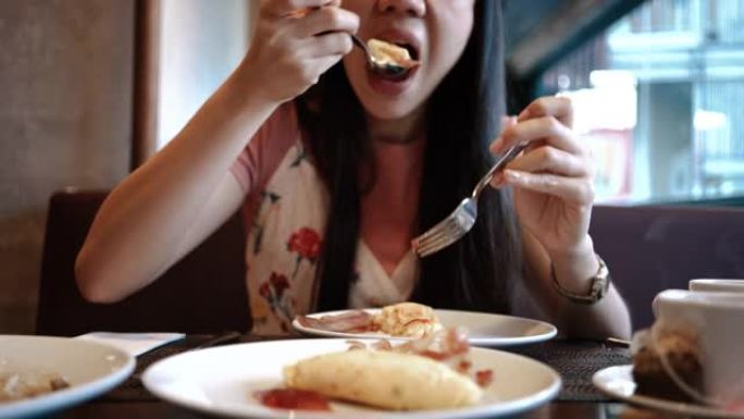 一个年轻女人在吃食物的特写镜头。