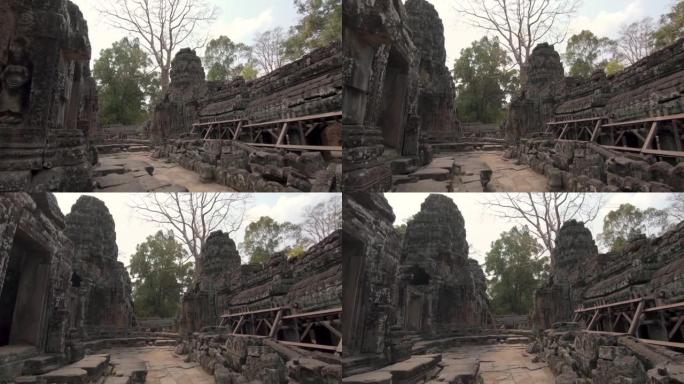 走在柬埔寨吴哥窟一座装饰华丽但却破败不堪的寺庙里