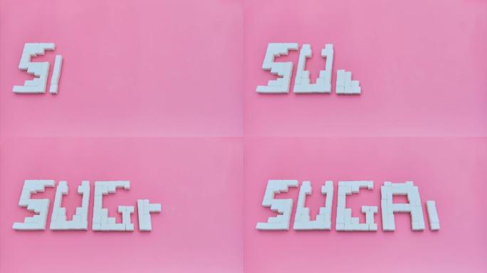 粉红色背景上的白色精制作品中的糖一词，慢动作