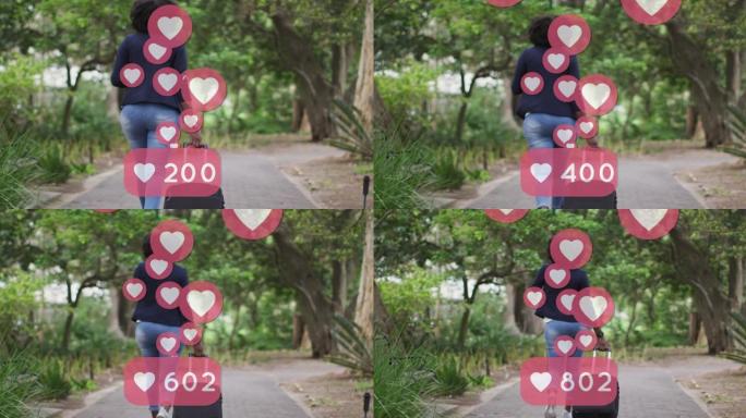 在公园骑自行车的非洲裔美国妇女身上的社交媒体心脏图标动画