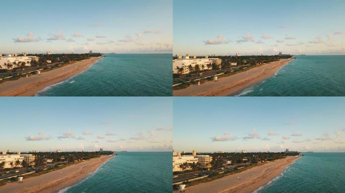 9月2021年日出时海浪席卷佛罗里达州棕榈滩的空中无人机视图