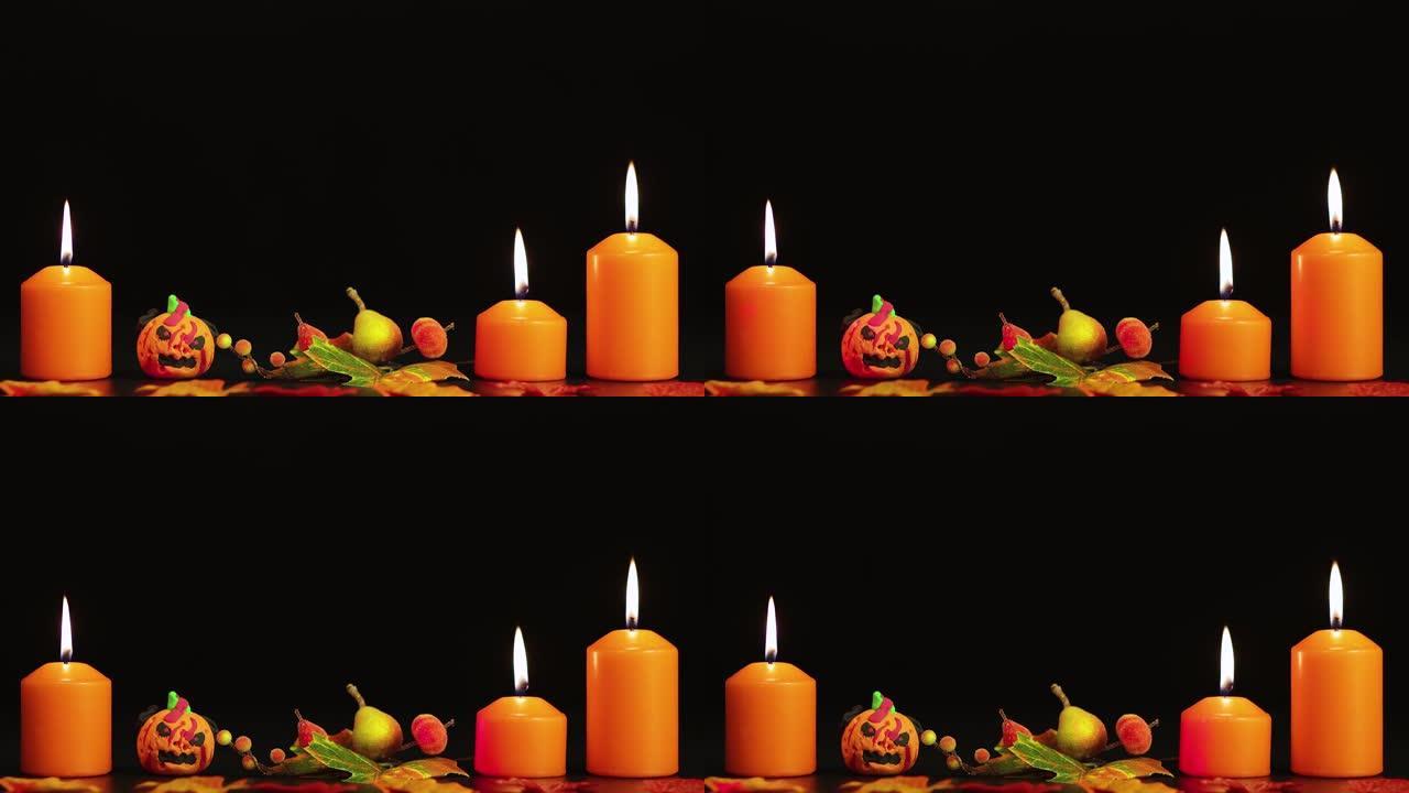 燃烧黄色蜡烛和令人毛骨悚然的南瓜，万圣节问候。