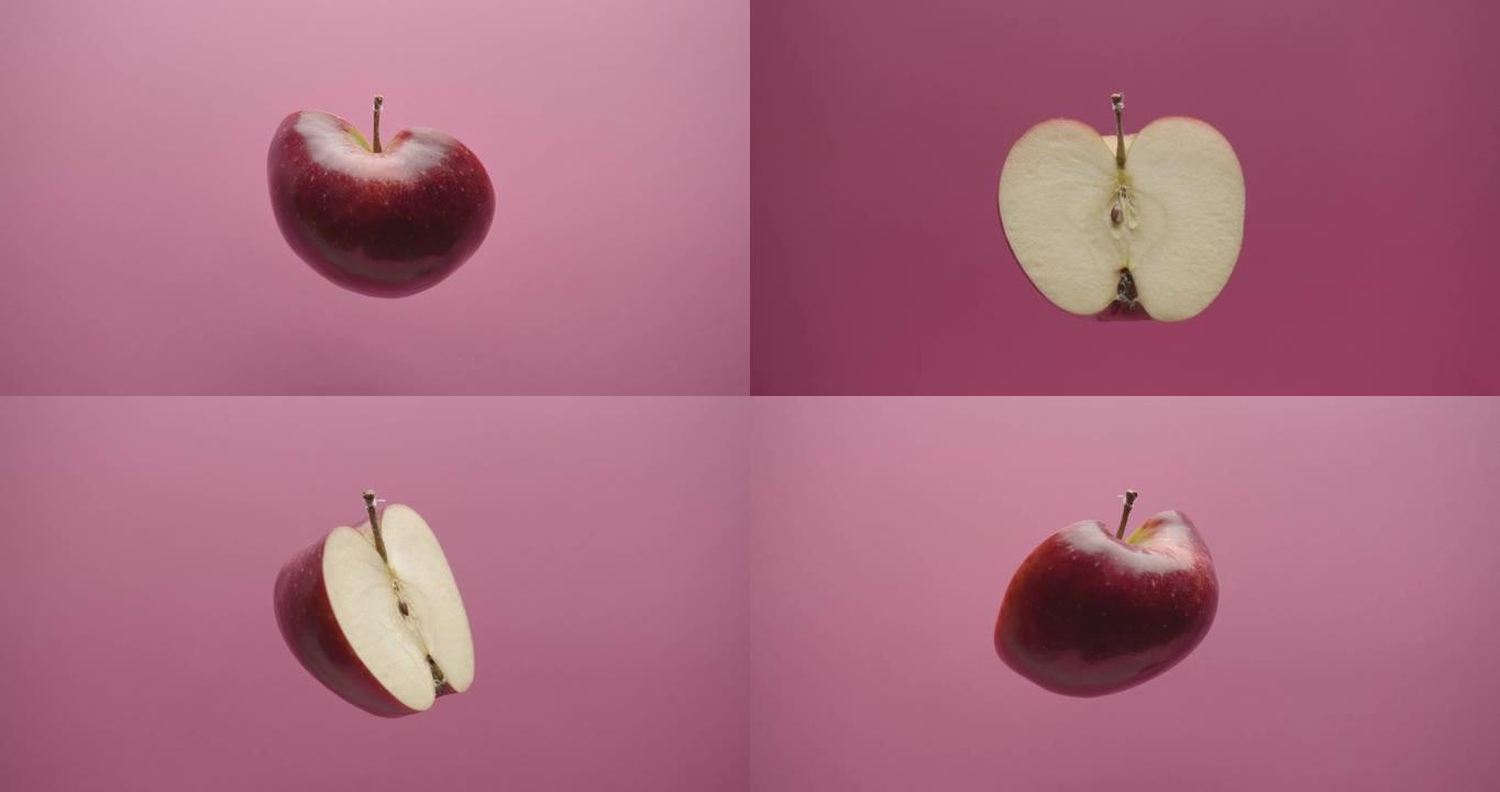 在红色背景上切成两半的美丽美味的苹果