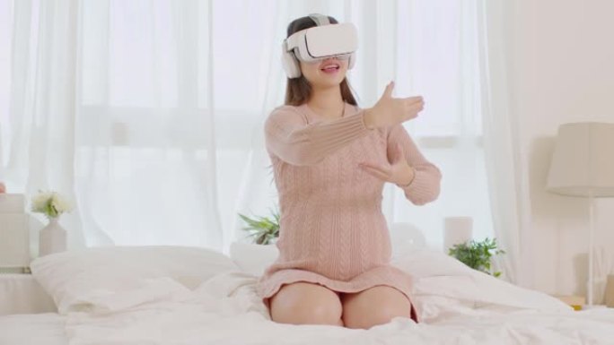 快乐孕妇使用虚拟现实眼镜练习教程照顾新生婴儿亚洲孕妇洁具护目镜使用虚拟现实或VR在家享受怀孕技术