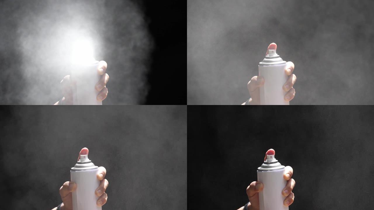 慢动作速度特写镜头在气溶胶的前视图中可以喷涂时，白色喷雾隔离在黑色背景上