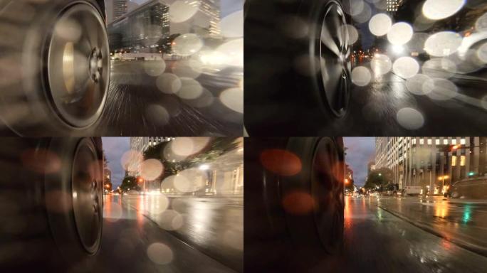 在雨夜开车穿过城市。汽车车轮的特写。在十字路口右转