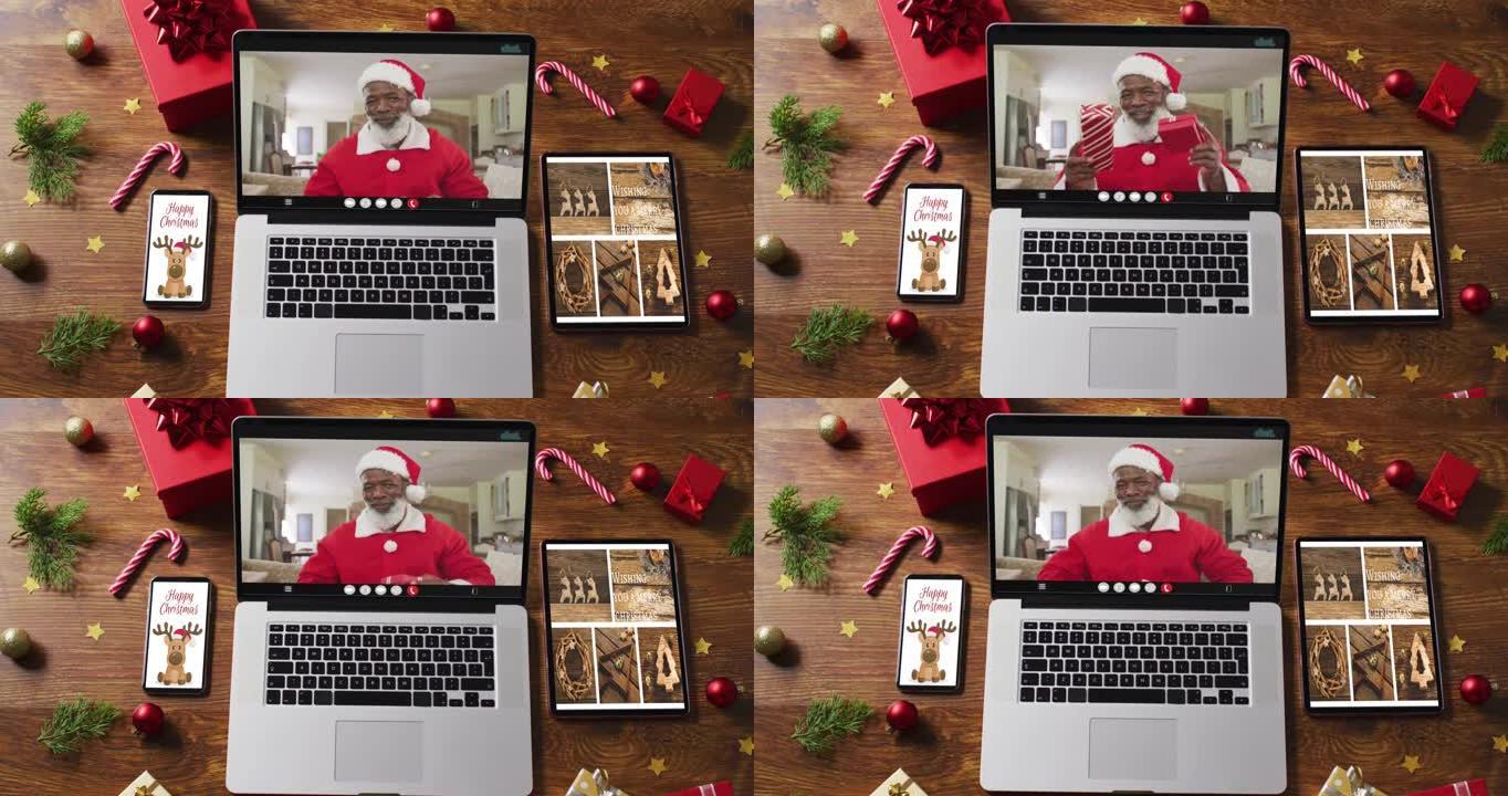 穿着圣诞老人服装的高级非洲裔美国人在视频通话中，配有智能手机、平板电脑和装饰品