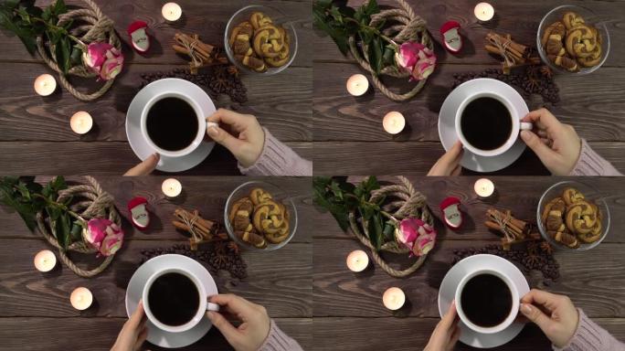 一个女人放下杯子，在浪漫装饰的桌子上拿起一杯咖啡。情人节