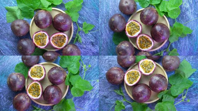 俯视木盘中的百香果，紫色百香果或木桌上带有叶子的Maracuya，4k分辨率。
