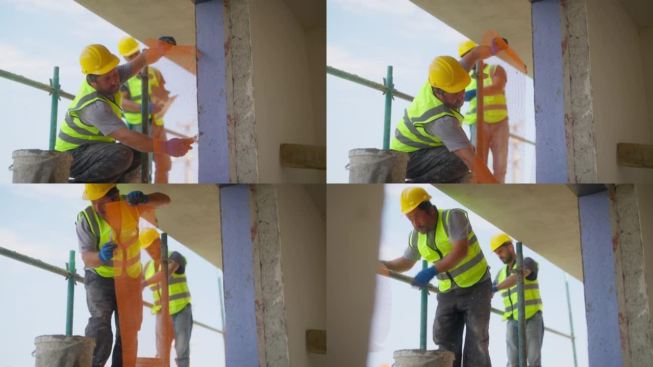 建筑工人在建筑立面上涂石膏