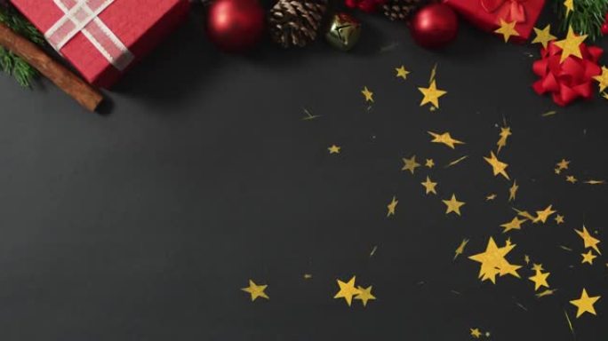 圣诞明星的动画落在带有装饰和复制空间的黑色背景上