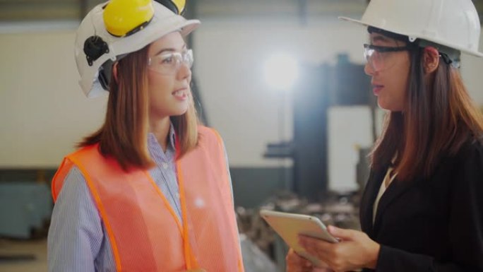 两名亚洲女工业工程师在车间检查工作的肖像